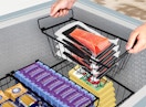 baskets in a deep freezer filled with food packages 