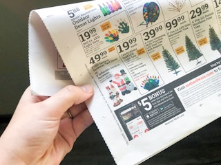 hand holding Ace Hardware ad