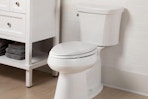 white toilet with closed lid