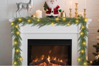 Artgar Christmas Cedar Garland draped over a hearth.