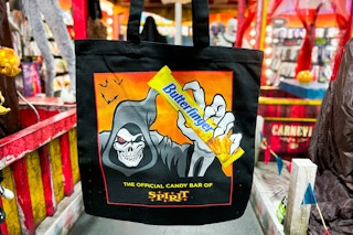 the spirit halloween free tote bag with their logo mascot holding a butterfinger candy bar