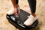 a woman using a vibration plate