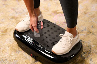 a woman using a vibration plate