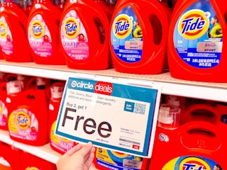 hand grabbing a b2g1 free sign on a target shelf