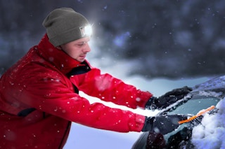 a guy outside in snow wearing a LED beanie