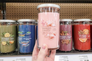 hand holding yankee jar candle at kroger
