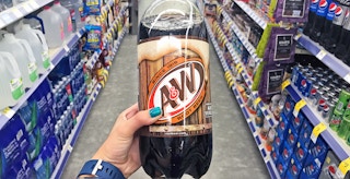 a hand holding up A & W root beer