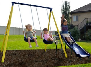 stock photo sportspower swingset with kids playing in yard or playground