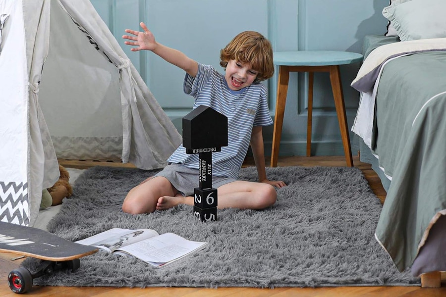 a boy on an area rug