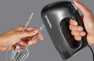 a person holding a hand blender 