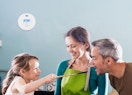 a carbon monoxide detector on a wall behind a family