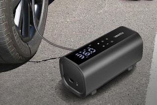 Portable Air Compressor being used on tire