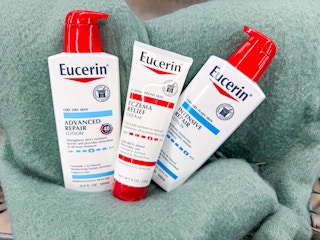 three bottles of eucerin laying on blanket at walmart