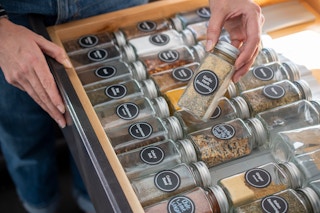 A drawer filled with spice jars