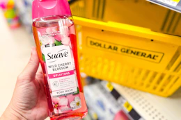 hand holding suave body wash in front of yellow basket
