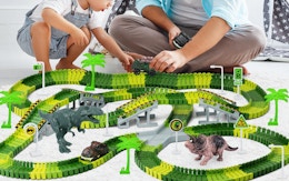 a dad and kid playing with a dinosaur racetrack 