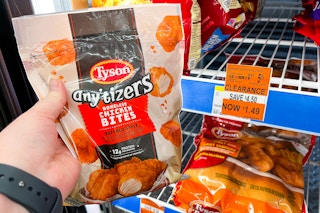 person holding a bag of tyson anytizers by a $1.49 clearance sign