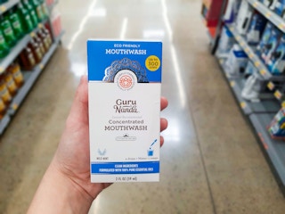 GuruNanda Concentrated Mouthwash product held in oral care aisle at Walmart