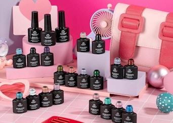 bottles of gel nail polish on a pink and white display