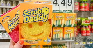 a person holding up a scrub daddy and mommy at target