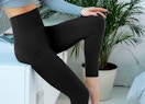 a person wearing legging while standing in a living room