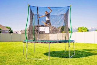 Lifestyle image of the Bounce Pro 10' Trampoline outdoors