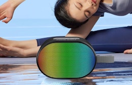 a person stretching next to a speaker