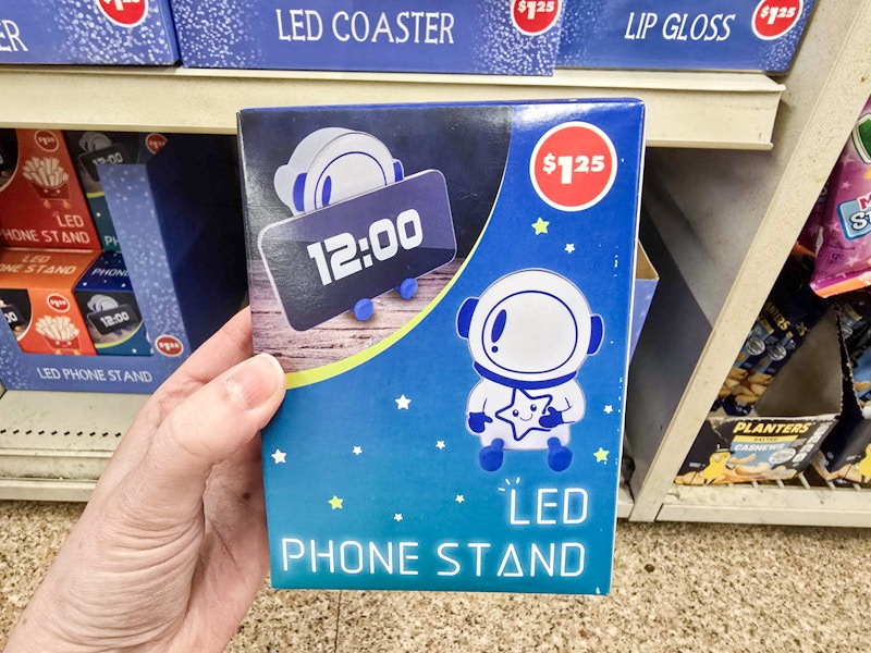 person holding an astronaut led phone stand