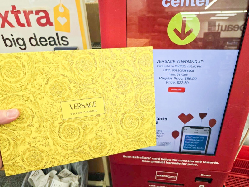 person scanning a fragrance gift set at a cvs price kiosk for $22.50