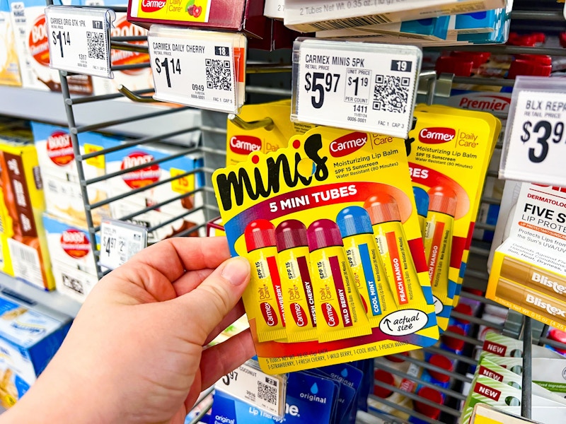 hand holding a pack of carmex minis lip balm at walmart