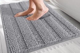 a person stepping on a bath mat