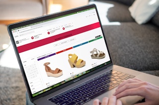 Person on a computer, online shopping for clearance shoes from DSW.com
