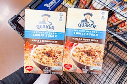 hand holding boxes of quaker oatmeal