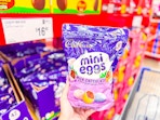 hand holding a bag of cadbury mini eggs at sams club