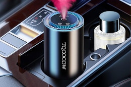  TQCOCOW Smart Car Air Freshener in a vehicle center console.