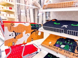 target halloween doormats sitting on a cart and shelf