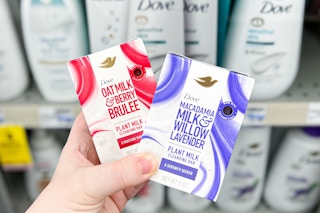 hand holding two Dove plant-based beauty soap bars