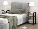 a bed next two two small nightstands with lamps
