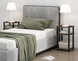 a bed next two two small nightstands with lamps