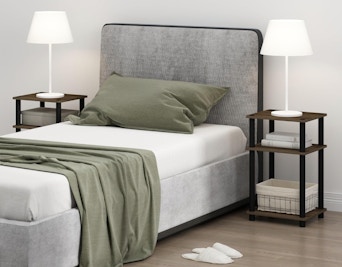 a bed next two two small nightstands with lamps
