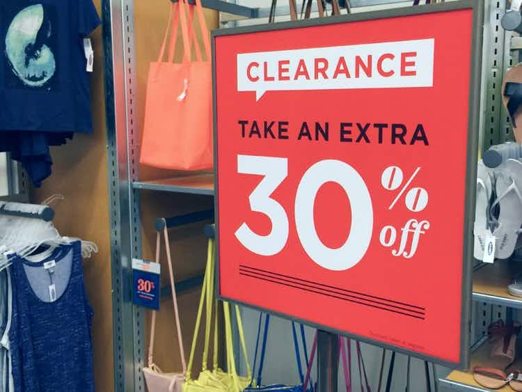 A clearance sign inside Old Navy that reads, "Clearance. Take an extra, 30% off"