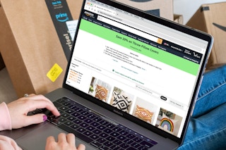 person on laptop looking at amazon throw pillows with coupon promo