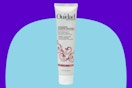 Ouidad styling hair cream on a blue background.