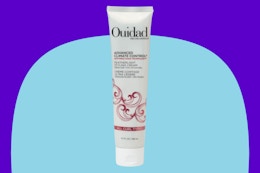 Ouidad styling hair cream on a blue background.