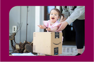 a baby near amazon boxes