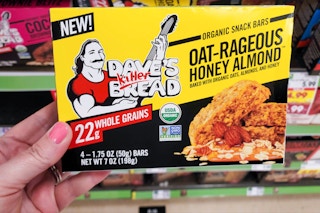 hand holding a box of daves killer bread snack bars