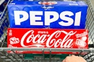 coca-cola and pepsi soda 12-packs in shopping cart