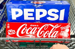coca-cola and pepsi soda 12-packs in shopping cart