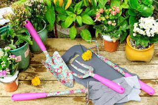 pink floral gardening tools on a gardening bench