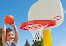 child playing with the Little Tike basketball hoop